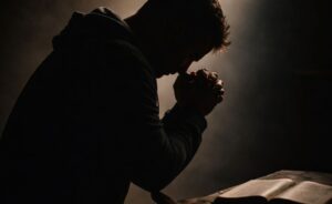 A silhouette of a man praying over a Bible, reflecting the blog's themes of seeking freedom from the crushing weight of shame through spiritual conviction.