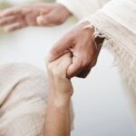 “Jesus holding a person’s hand in comfort and healing – Bible verses about healing and faith in God”